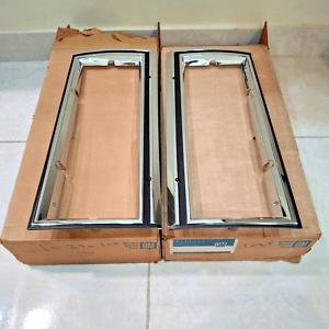 NOS GM 81-85 Impala Headlight Bezel Set 14015122 14015121