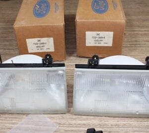 NOS Ford LH-RH headlight clusters with bulbs F23Z13008B - F23Z13008A 1992-1997