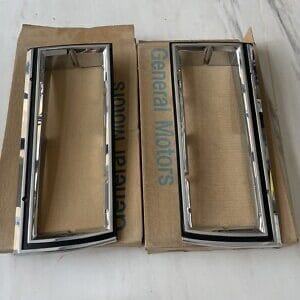 NOS GM 81-85 Impala Headlight Bezel Set 14015122 14015121